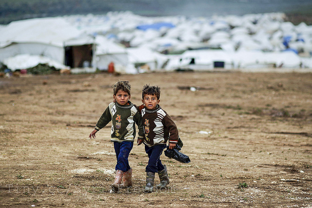 Syrian boys, whose family fled their home in Idlib, walk to their tent, at a camp for displaced Syrians, in the village of Atmeh, Syria, Monday, Dec. 10, 2012 Photo by Freedom House 
